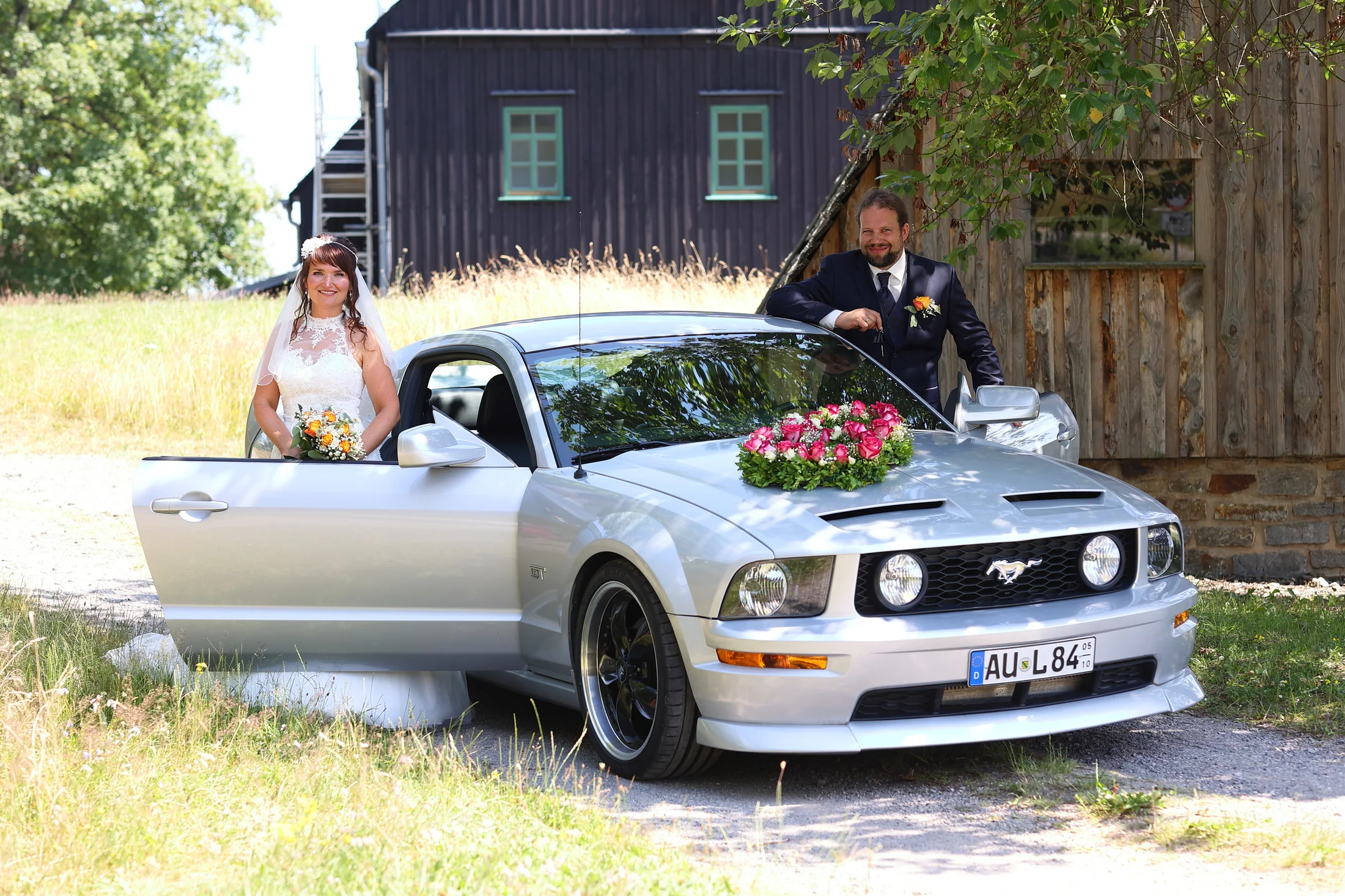 Katrin und Jens mit ihrem Mustang beim Paarshooting in Schneeberg